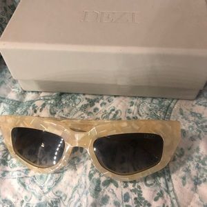 Dezi on read sunglasses in limestone